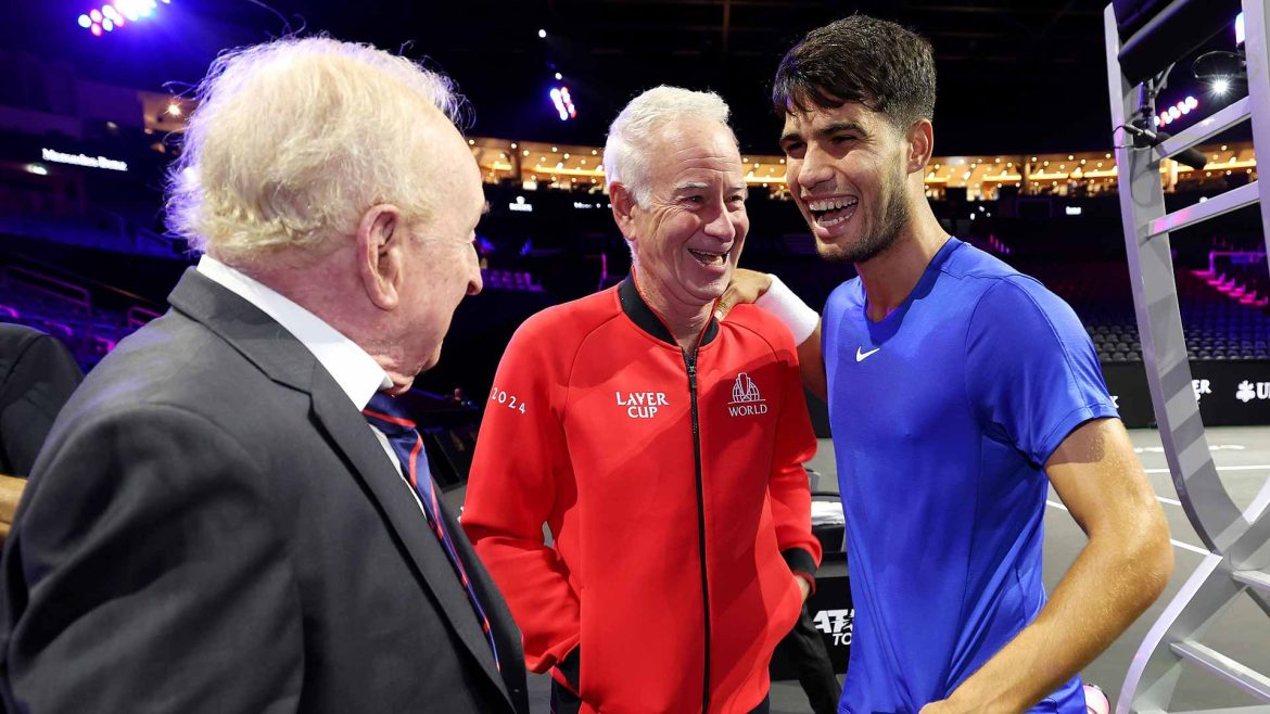 Carlos Alcaraz, in blue shirt, chats with retired tennis legend John McEnroe (in red jacket) in Berlin during a practice break. Alcaraz is making his debut at the Laver Cup for Team Europe this weekend.