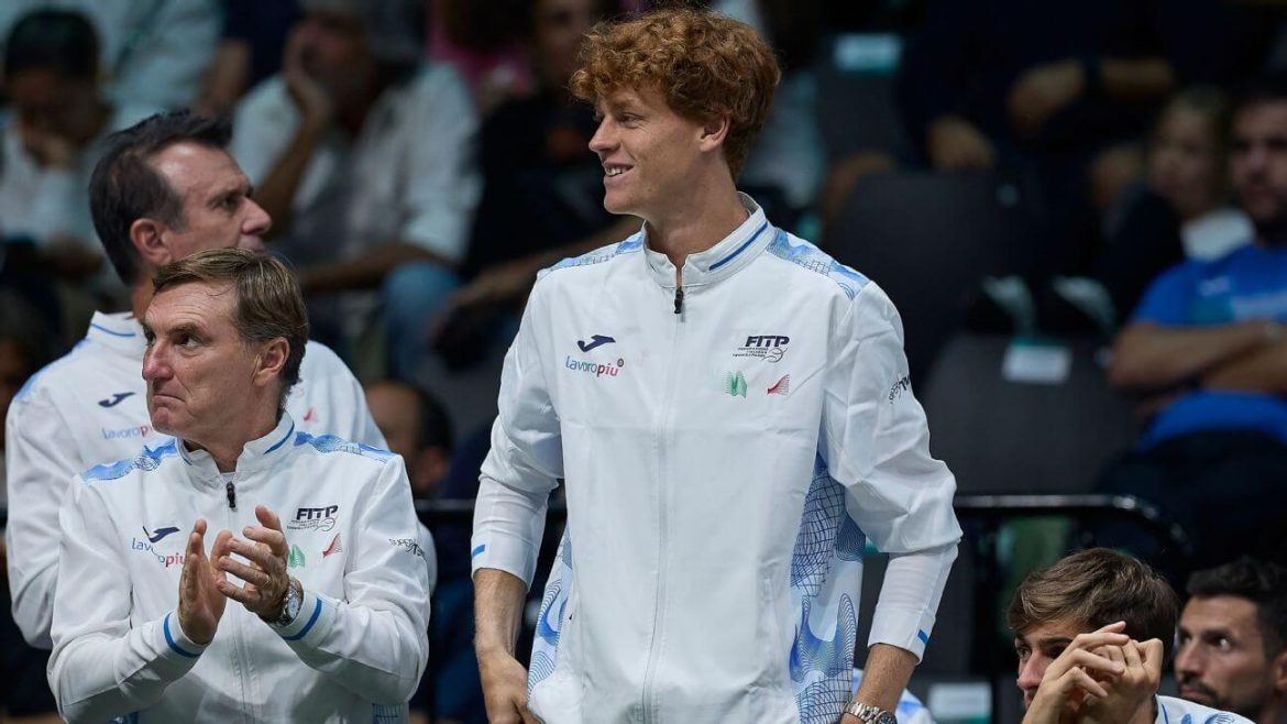 Jannik Sinner, in white uniform, looks on to the crowd during a match break. Sinner announced the addition of two new members of his team on Monday.