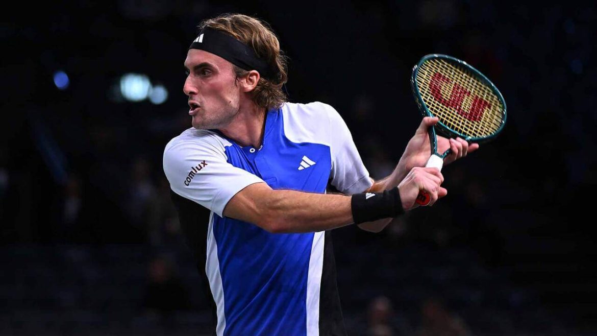 Greece's Stefanos Tsitsipas, in blue and white shirt, attempts to return a shot at the 2024 Paris Masters on Monday. Tsitipas wins Paris Masters opener