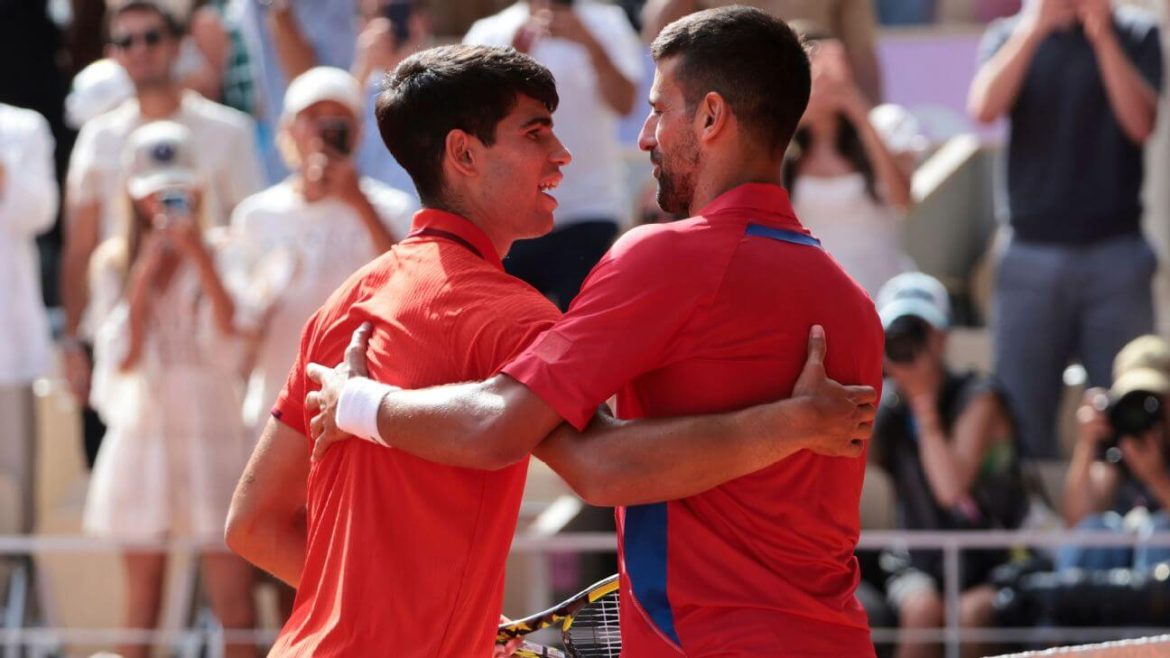 Spain's Carlos Alcaraz (left) and Serbia's Novak Djoovic (right) share a light embrace and a conversation after a match in file photo. Djokovic gets tough Australian Open route, draws Alcaraz, Zverev