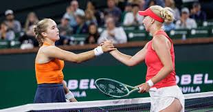 Russia's Mirra Andreeva (left) shakes hands with Denmark's Clara Tauson after their match on Monday. Andreeva in Indian Wells' last 16, sets record after beating Tauson