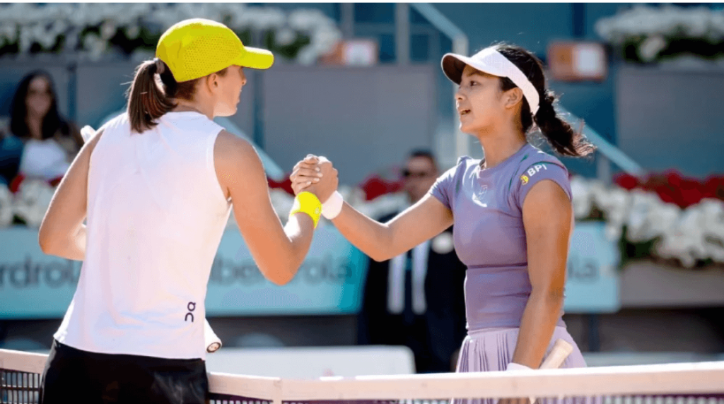 Poland's Iga Swiatek (left) and Alexandra Eala of the Philippines (right) shake hands at center court in another close fight in Madrid on Thursday. Swiatek rallies to get back at Eala in Madrid