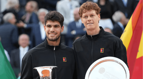 Spain's Carlos Alcaraz (left) and Italian Jannik Sinner (right) pose with their trophies after their Italian Open men's singles final on Sunday. Alcaraz denies Sinner home win at Italian Open; Paolini tops Gauff