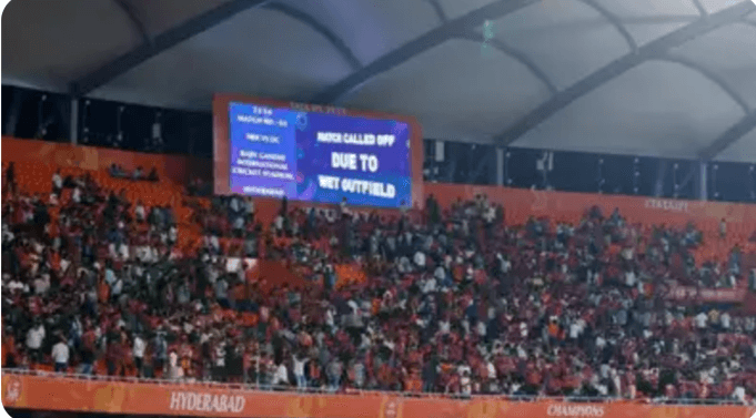 A video monitor informs fans that the match between Delhi Capitals (DC) and Sunrisers Hyderabad (SRH) has been called off due to wet outfield at the Rajiv Gandhi International Stadium. DC vs SRH match washed out; Sunrisers out of IPL playoff race