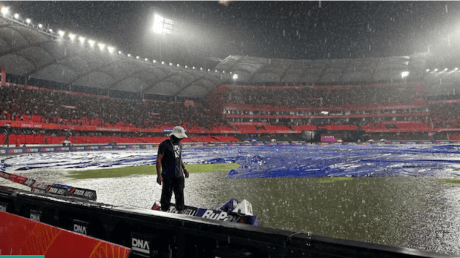 A worker tried to cover a part of the pitch as the match between Delhi Capitals (DC) and Sunrisers Hyderabad (SRH) has been called off due to wet outfield at the Rajiv Gandhi International Stadium. DC vs SRH match washed out; Sunrisers out of IPL playoff race
