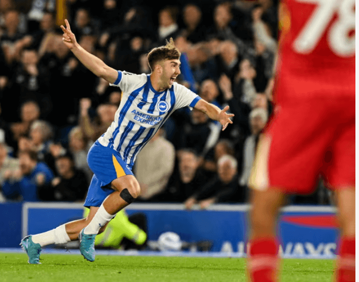 Brighton substitute Jack Hinshelwood spreads his arms in celebration as seen in the Seagulls' match againt Liverpool on Monday night. Brighton vs Liverpool match has Seagulls keep European spot alive