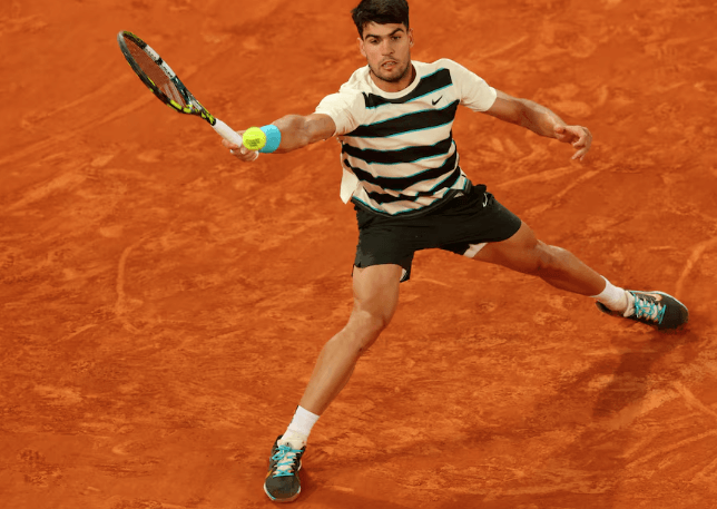 Spain's Carlos Alcaraz stretches for a shot in his French Open quarterfinal vs American Tommy Paul on Tuesday. Swiatek, Sabalenka arrange French Open semis clash; Alcaraz in last four