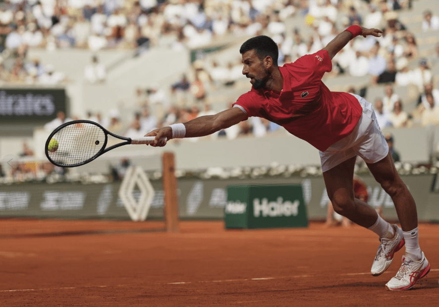 Serbian Novak Djokovic stretches to hit a shot in his French Open match against Cam Norrie on Monday. Djokovic gets 100th French Open win; Gauff wins, Pegula ousted