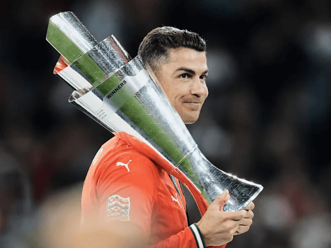 Superstar Cristiano Ronaldo holds the trophy after he helped Portugal win its second Nations League title over Spain in the final on Sunday. Ronaldo to stay at Al Nassr after Portugal's Nations League title win
