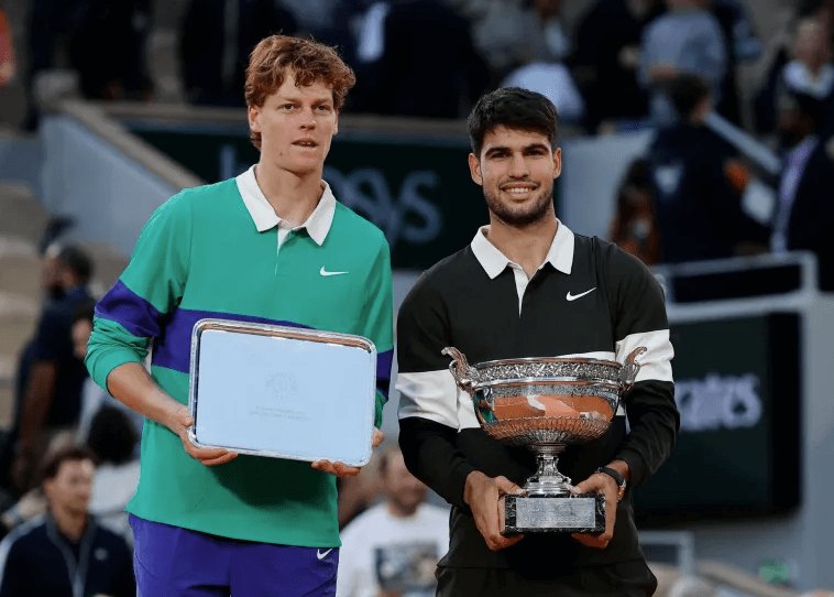 Spain's Carlos Alcaraz (right) and Italy's Jannik Sinner (left) pose for photographers with their trophies after their French Open 2025 final on Sunday. Alcaraz beats Sinner, win French Open title; Gauff tops Sabalenka