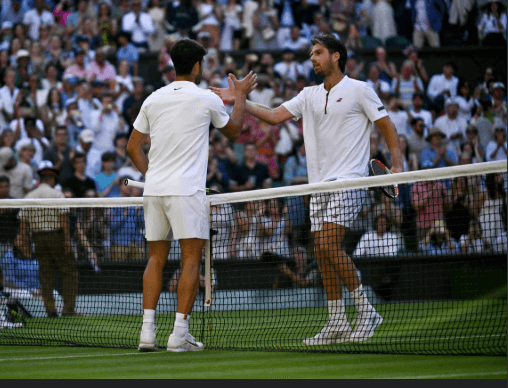 Spain's Carlos Alcaraz (left) shakes hands with Britain's Cam Norrie at center court after their Wimbledon quarterfinals match on Tuesday. Alcaraz to face Fritz in Wimbledon semis; Sabalenka survives
