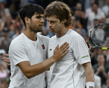 Spain's Carlos Alcaraz (left) consoles Anrey Rublev (right) after their round-of-16 wimbledon match on Sunday. Alcaraz tops Rublev to get Wimbledon last 8; Sabalenka in quarters