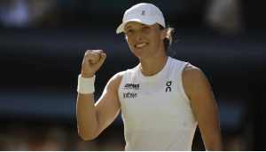 Poland's Iga Swiatek pumps her first at the Wimbledon women's singles final awarding ceremony after she won the title on Sunday. Swiatek rises to No.3 in WTA rankings; Sinner, Alcaraz top men