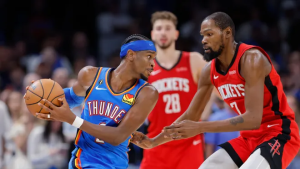 OKC guard Shai Gilgeous Alexander (left) protects the ball against Houston Rockets forward Kevin Durant (right) in their NBA opening-night matchup on October 21, 2025.