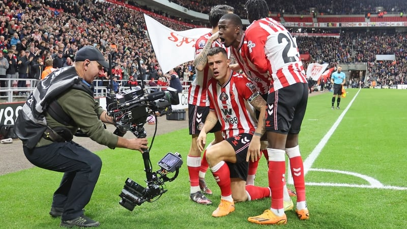 Granit Xhaka (middle, kneeling) was mobbed by his teammates after hius second-half goal secured a draw for Sunderland against Everton.